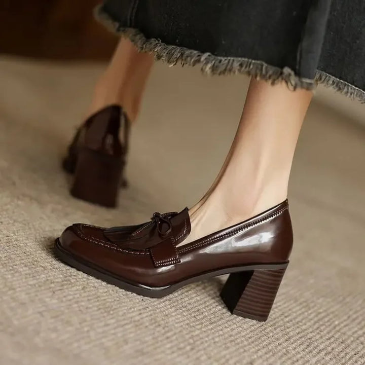 Vivienne tassel loafer pump in glossy black, sole view