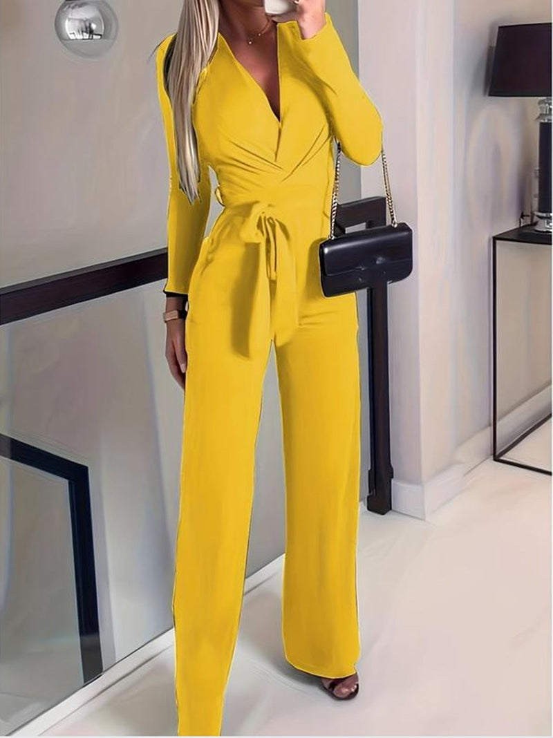 Side view of the Vivienne jumpsuit in ivory highlighting the adjustable tie waist and elongated wide-leg cut