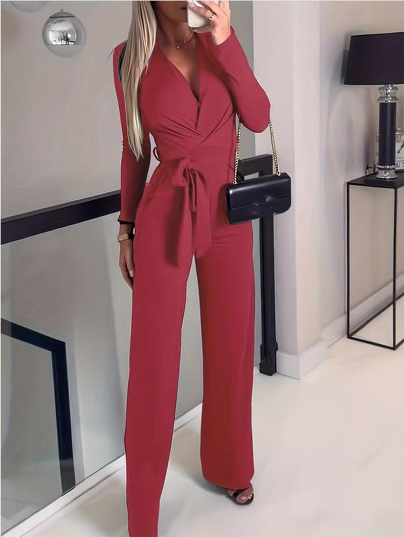 Close-up of the wrap V-neckline and self-tie belt detail on the Vivienne jumpsuit in red