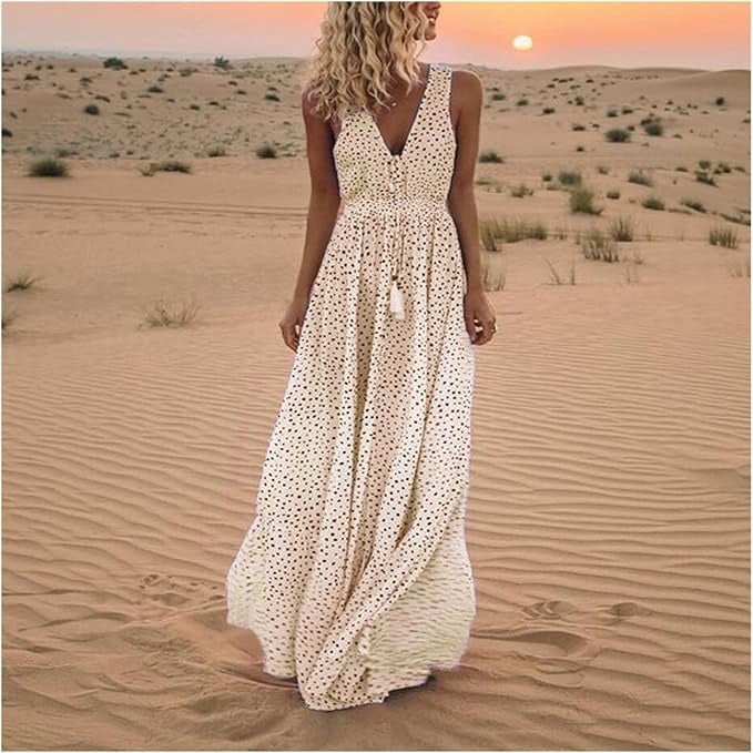 Woman wearing a flowy beige polka dot boho maxi dress with a cinched waist and draped skirt