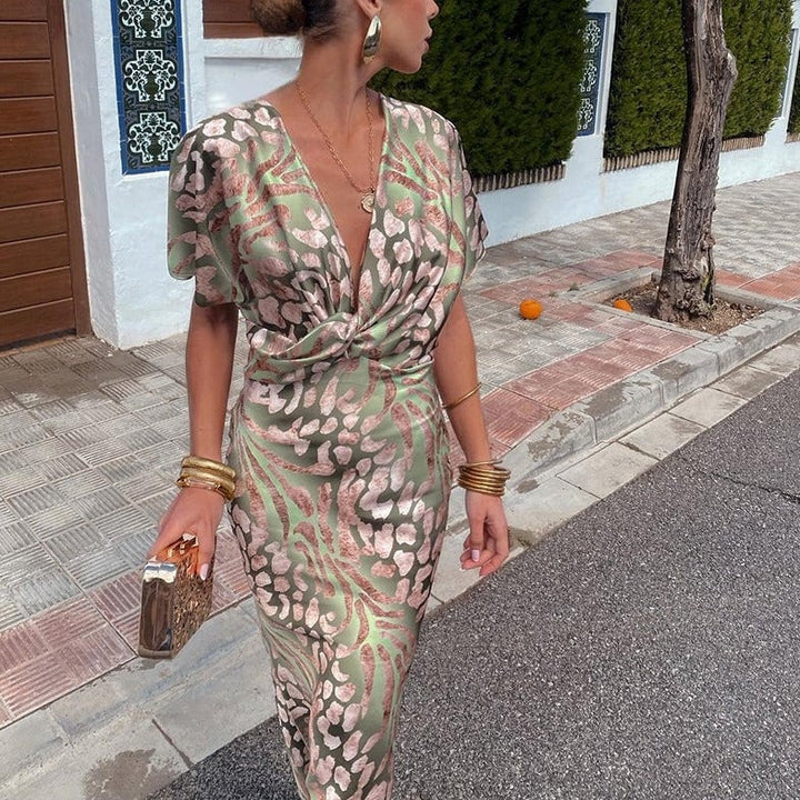 Woman in the Waverly dress styled with strappy heels for a wedding guest look, side view