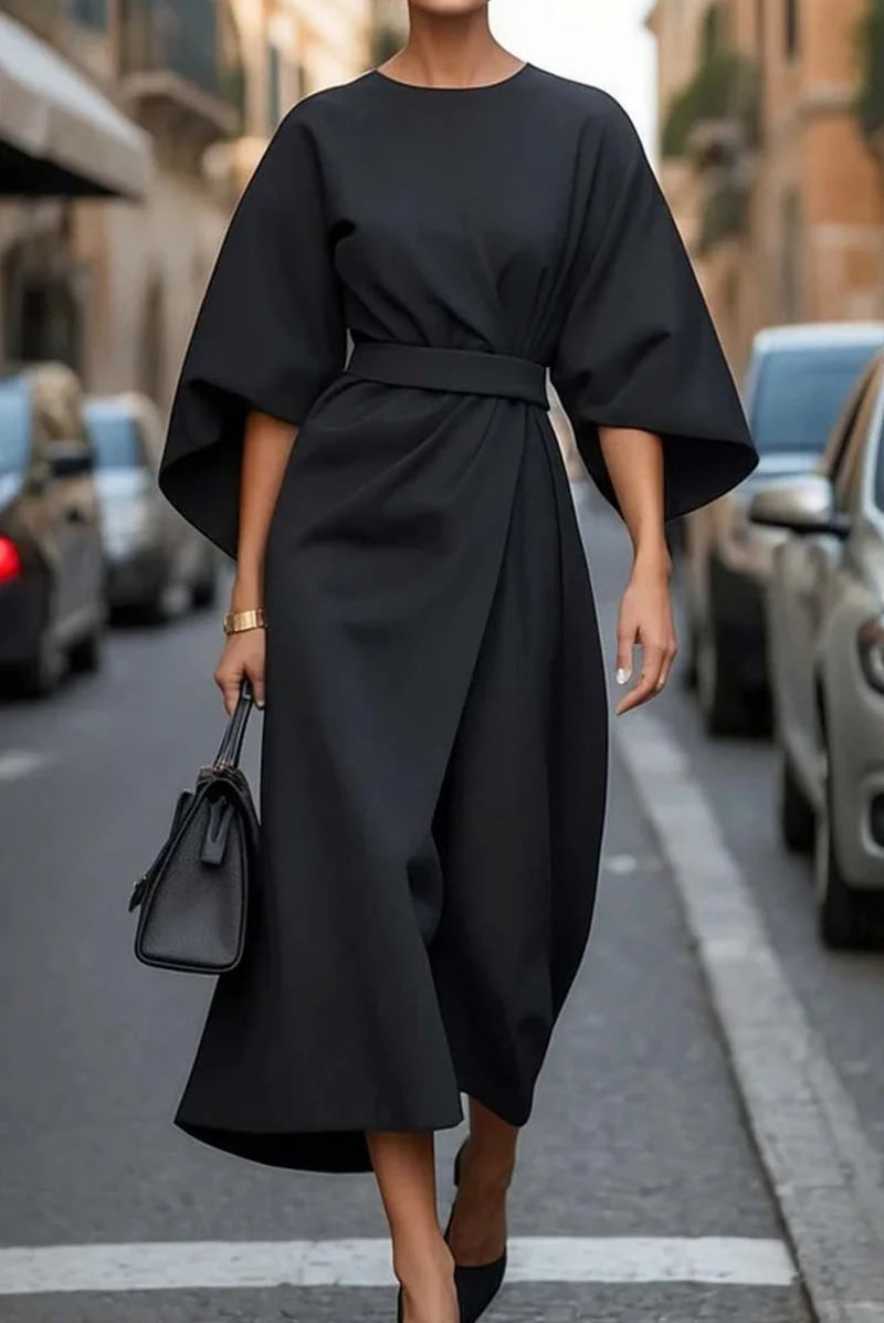 Woman in the Wendy dress in burgundy styled with heels for an evening occasion