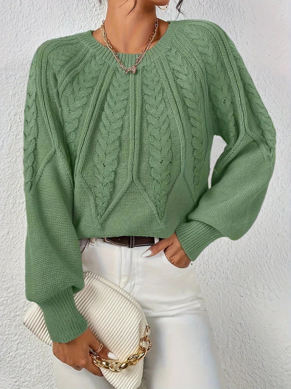 Woman wearing the Willow cable-knit sweater in a relaxed fit, showcasing intricate cable-knit texture and a flattering silhouette
