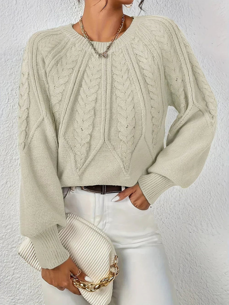 Full-length lifestyle shot of the Willow cable-knit sweater styled with jeans for a casual everyday look