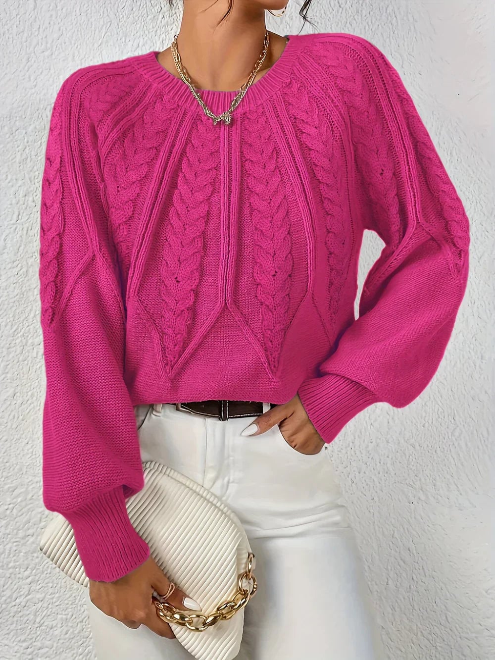 Model wearing the Willow cable-knit sweater in a light neutral tone, paired with tailored trousers