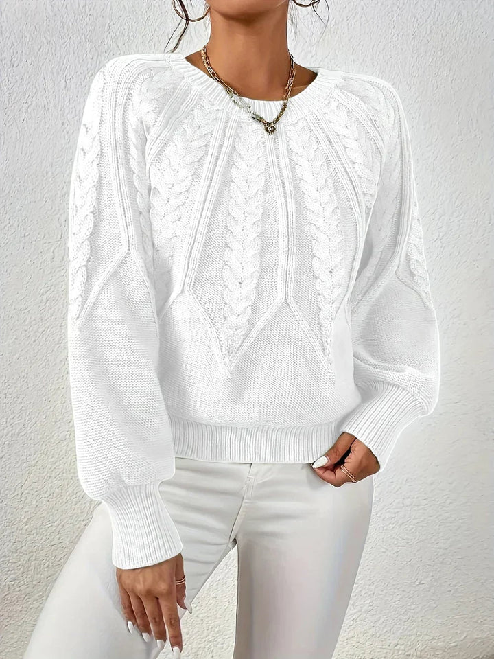 Overhead flat-lay of the Willow cable-knit sweater showing color and knit detail