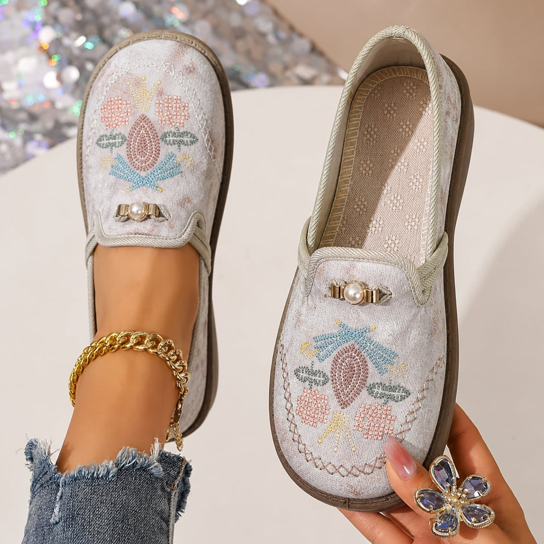 Side view of Willow floral loafers in gray showing intricate embroidery and pearl accent details