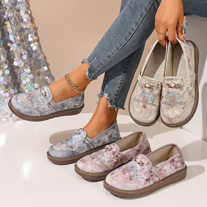 Close-up detail of Willow loafer floral embroidery and pearl accents showing artisan beaded craftsmanship