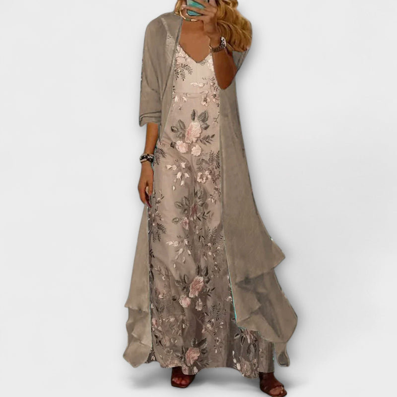 Woman wearing a floral V-neck maxi dress layered with a longline open-front cardigan in blue, shown in full length