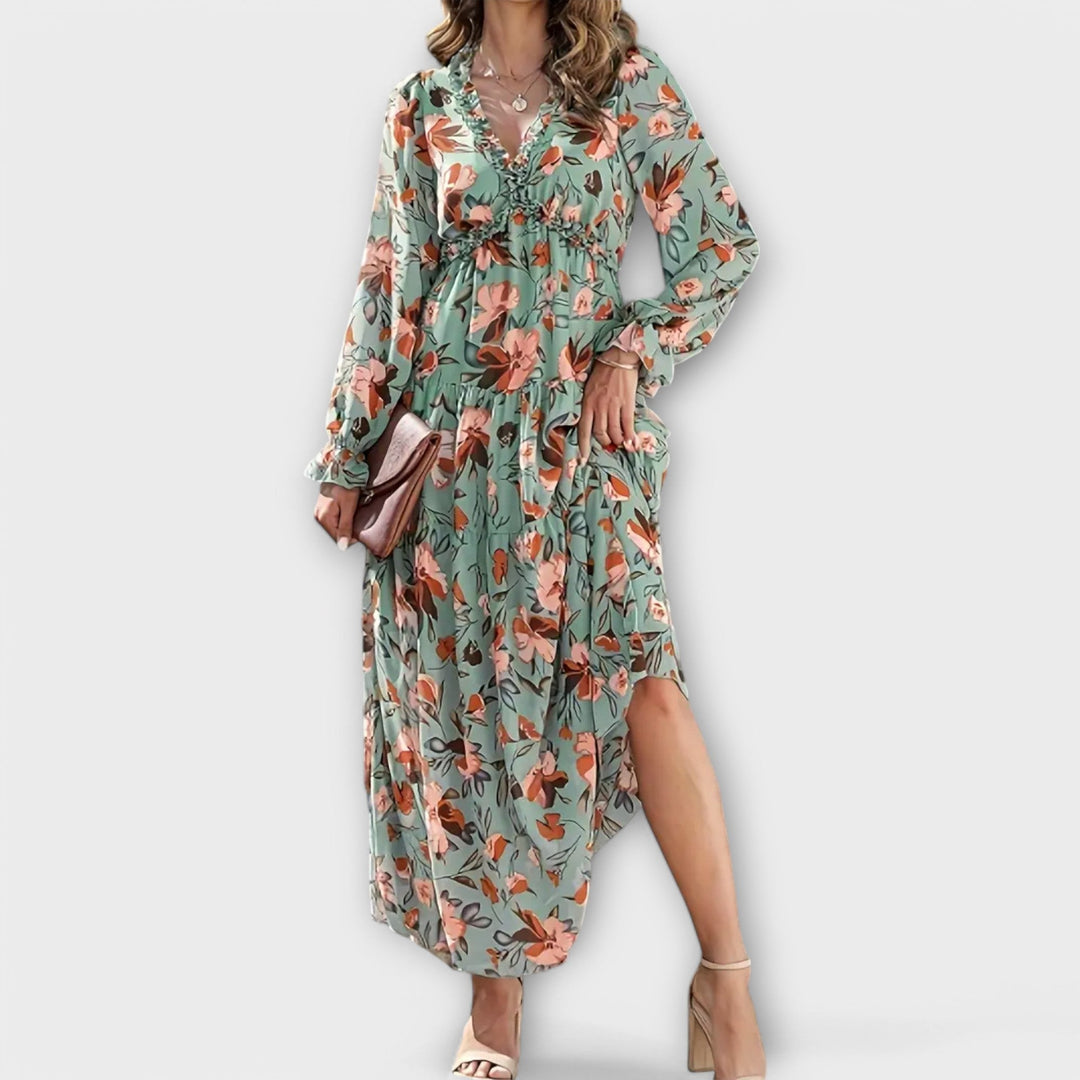 Front view of a floral maxi dress in pink showing the V-neckline and full-length hem