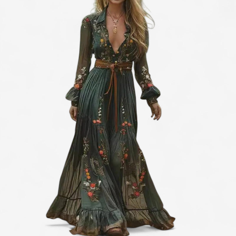 Model wearing a flowing multicolor floral embroidered maxi dress with intricate detailing and a graceful silhouette