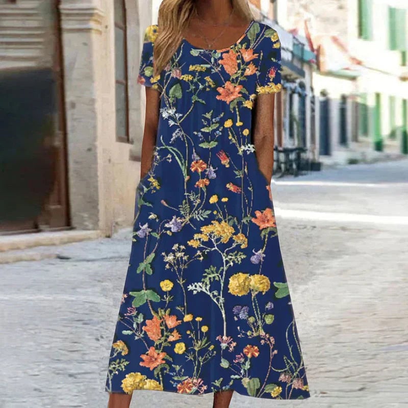 Woman wearing a vibrant floral short sleeve midi dress with a relaxed fit, shown from the front