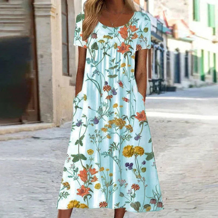 Back view of a floral short sleeve midi dress featuring a botanical print and elegant midi hemline