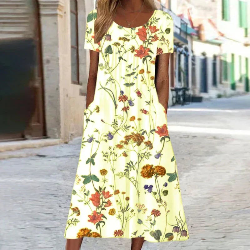 Side profile of a woman in a floral midi dress highlighting the relaxed silhouette and short sleeves