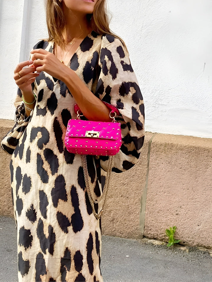 Woman wearing a bold leopard print tummy control draped dress with a flattering, smoothing silhouette