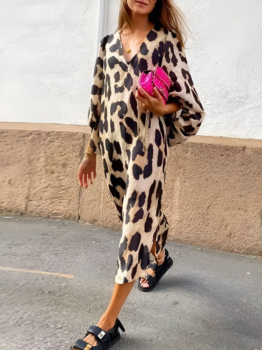 Front view of a leopard print draped dress showing the feminine neckline and flowing fabric