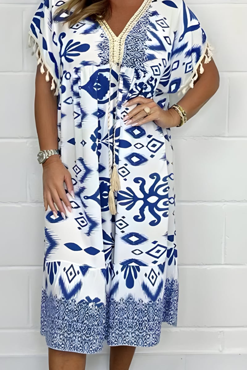 Woman wearing a light blue loose fit draped midi dress with a relaxed silhouette and mid-length hemline