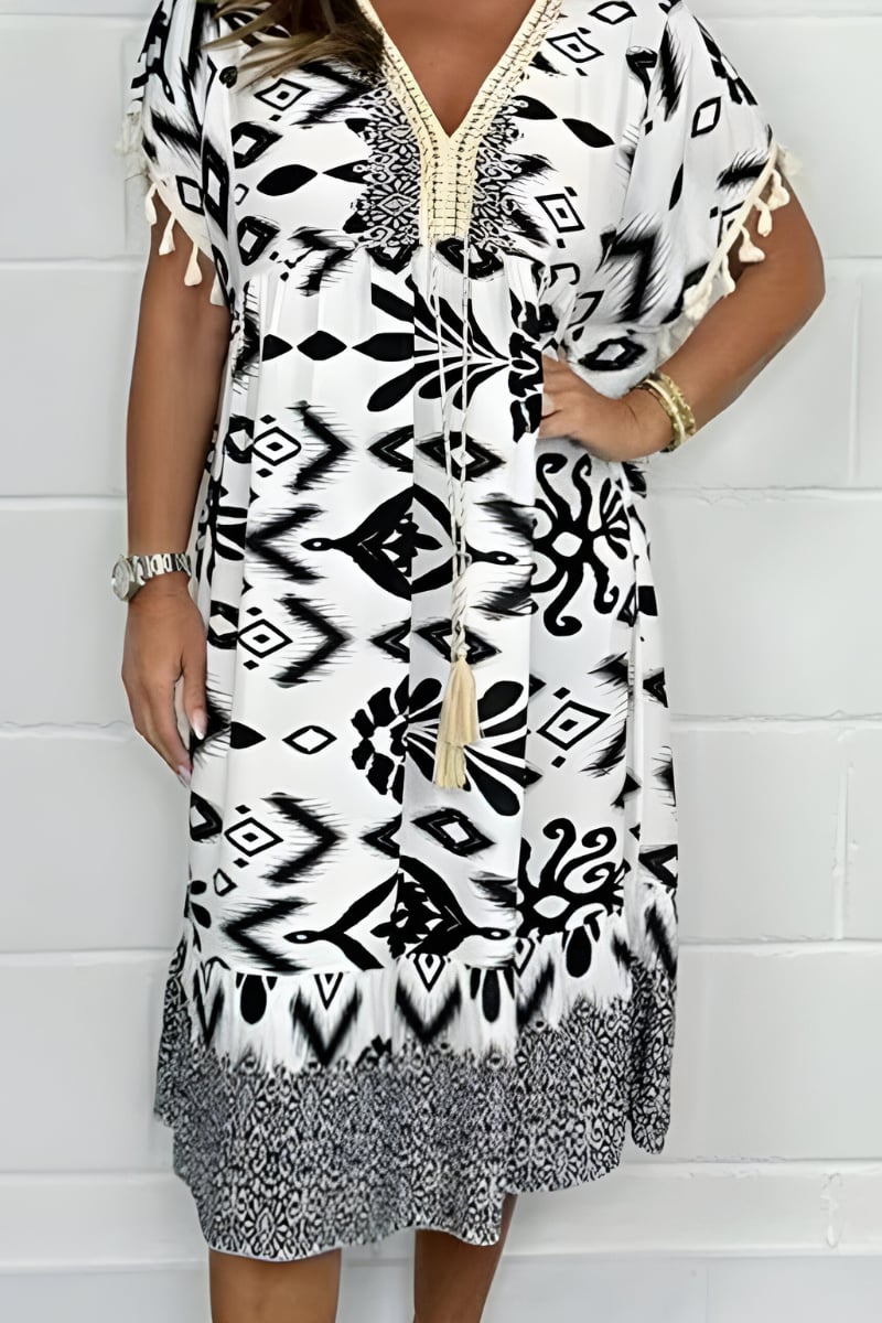 Side view of a black loose fit midi dress highlighting the graceful drape and breathable lightweight fabric