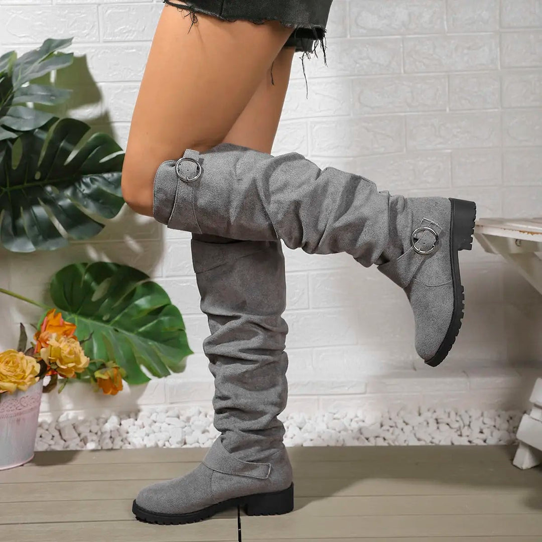 Side profile of Wyn knee high boots showing tall streamlined design and supportive sole