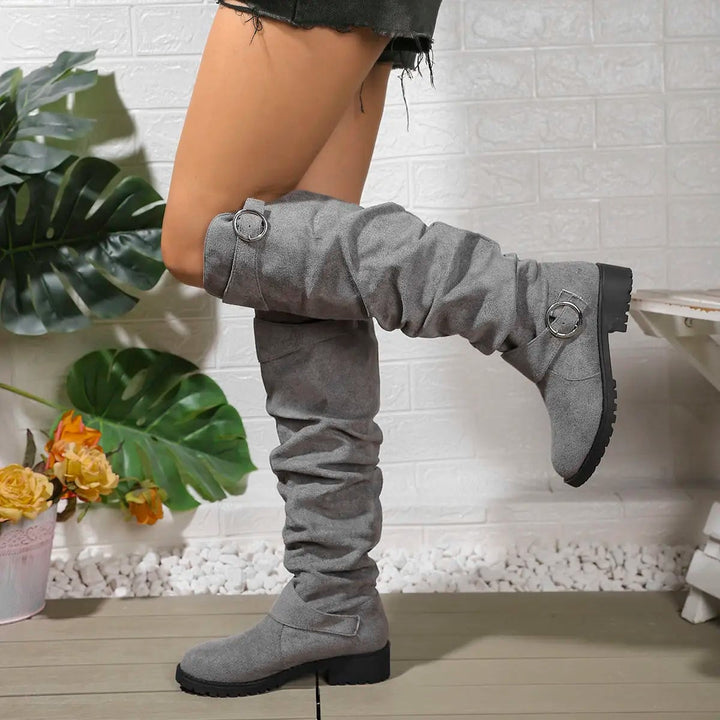 Side profile of Wyn knee high boots showing tall streamlined design and supportive sole