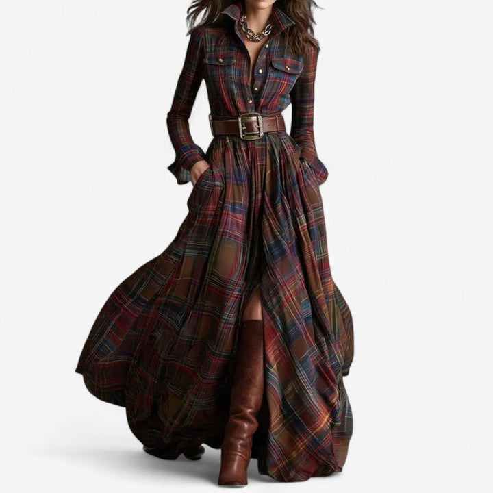 Model wearing the Xandra timeless maxi dress in reddish brown, featuring a flowing silhouette and elegant draping fabric