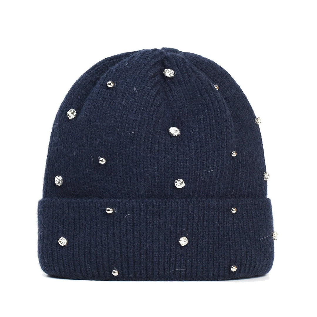 Close-up of beaded sparkle accents on a cozy knit beanie in beige