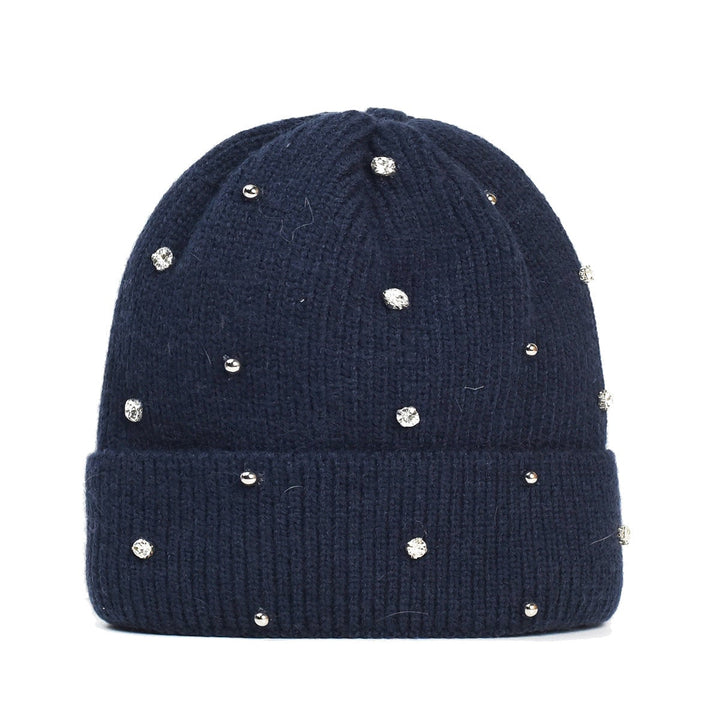 Close-up of beaded sparkle accents on a cozy knit beanie in beige