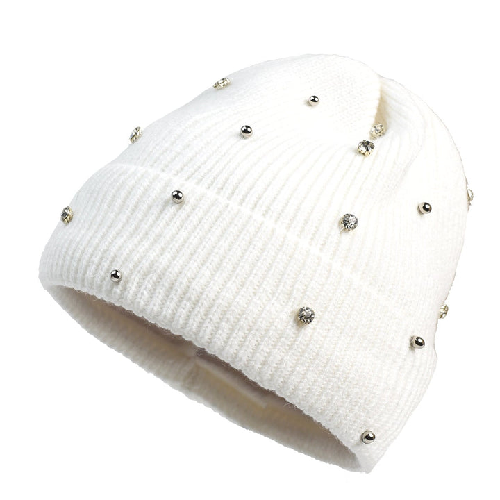 Woman wearing a pink cozy beanie with subtle sparkle details in a winter setting
