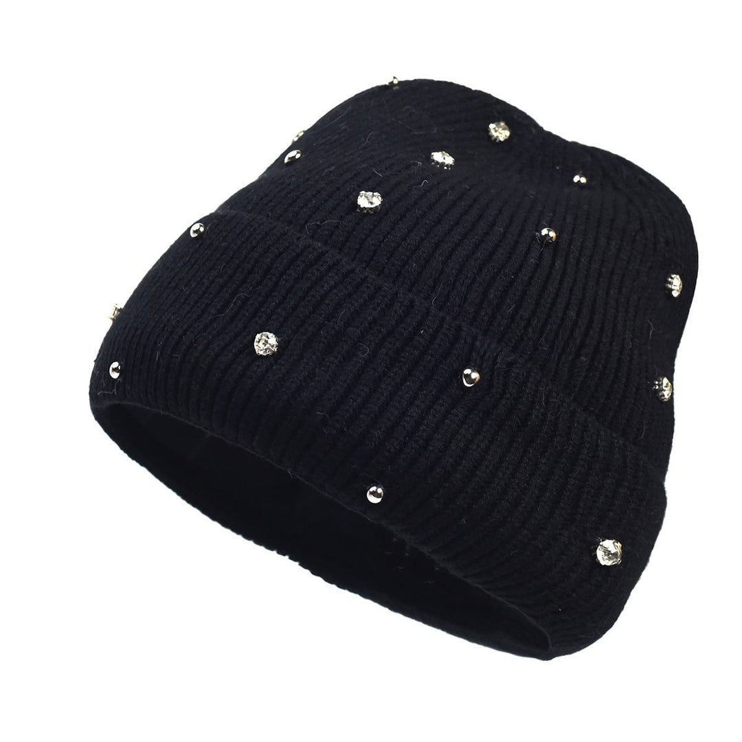 Overhead flat lay of all five beanie color options: navy, beige, white, black, and pink