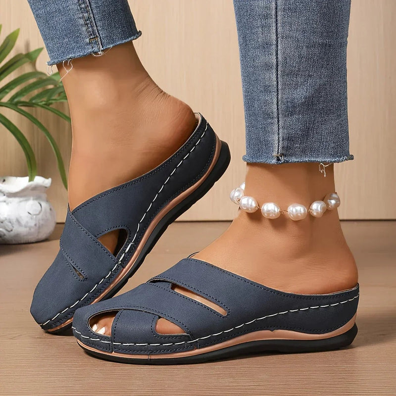 Women's platform wedge sandals in blue with secure straps and cushioned sole, front view