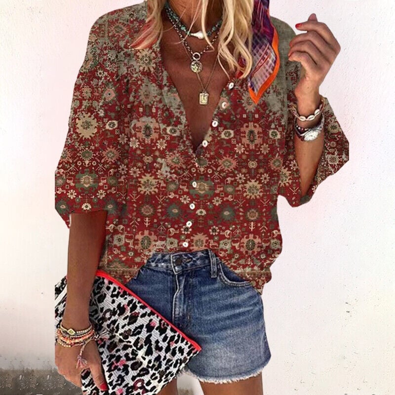 Woman styled in a brown boho print long sleeve blouse paired with casual trousers