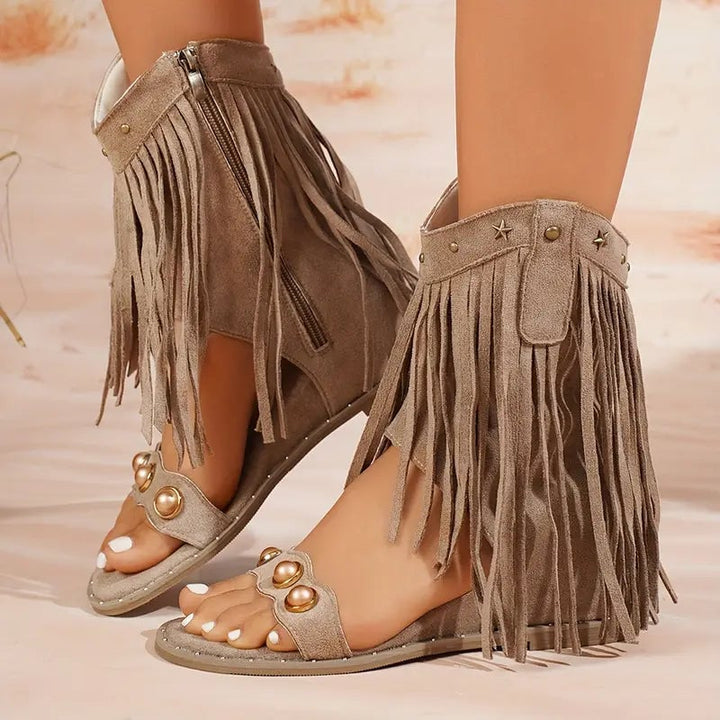 Khaki fringe ankle sandals with metallic stud accents and zipper closure, front view