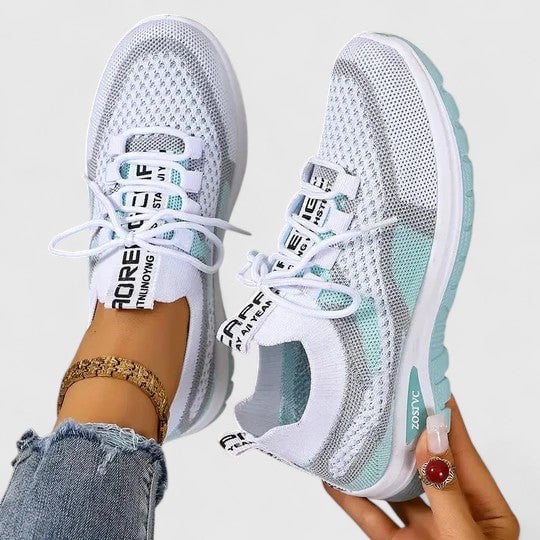 Side view of women's mesh sneakers with bold typographic lace accents in turquoise