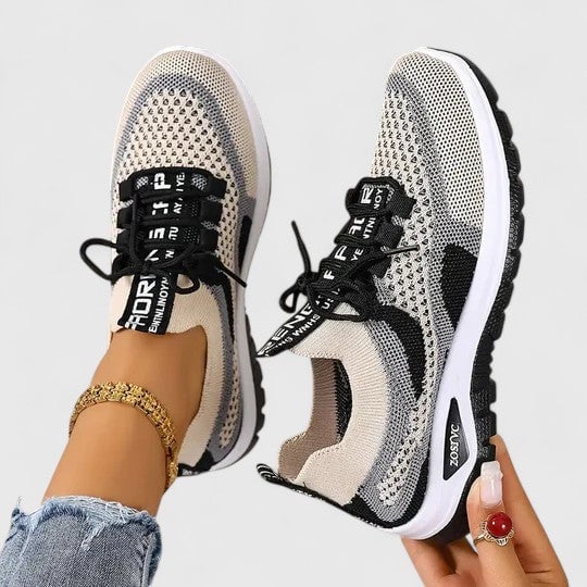 Women's black mesh lace-up sneakers with graphic side panel detail