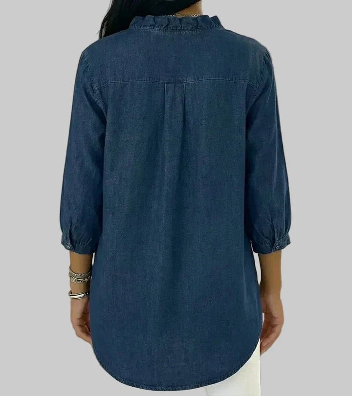 Close-up of ruffle V-neckline detail on 3/4 sleeve blouse in apricot