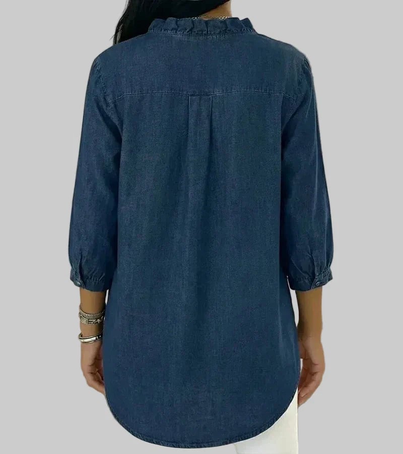 Close-up of ruffle V-neckline detail on 3/4 sleeve blouse in apricot