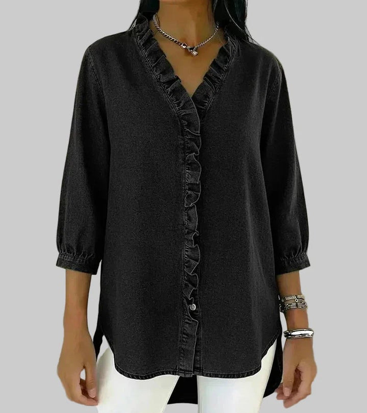 Side view of relaxed-fit ruffle blouse in gray showing 3/4 sleeve length