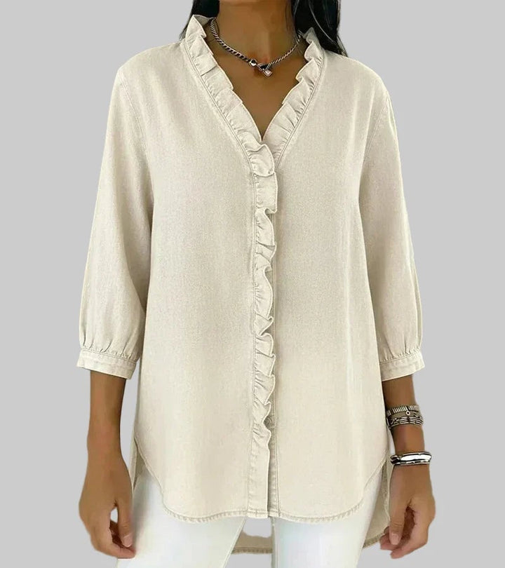 Flat lay of ruffle V-neck blouse in dark blue highlighting fabric and sleeve detail