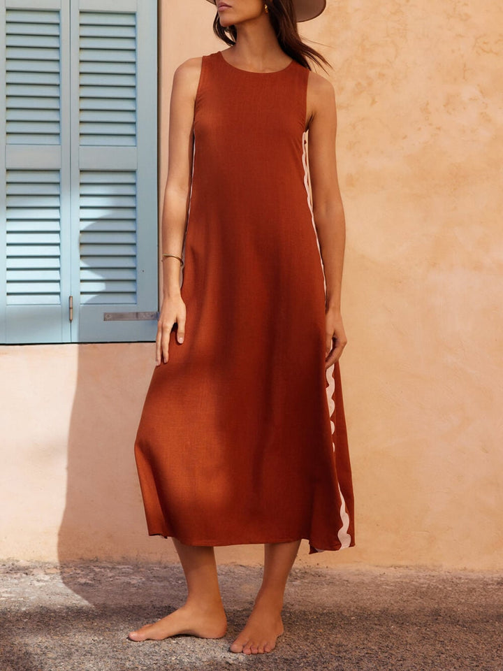 Close-up of wavy contrast trim detail on brown midi dress highlighting the ric-rac design