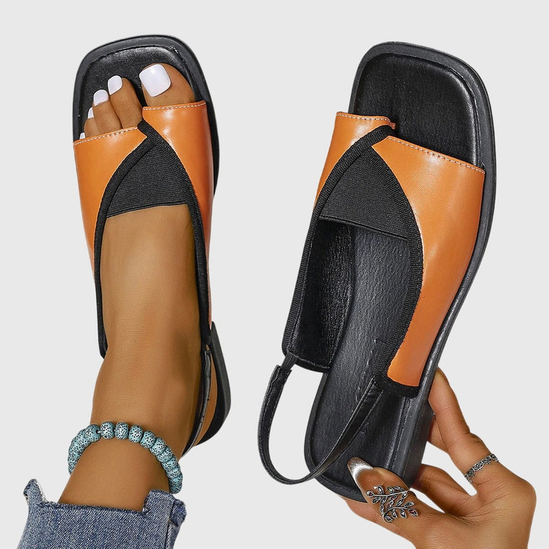 Women's square toe colorblock flat sandals in orange, showcasing the slip-on silhouette and slingback strap, side view