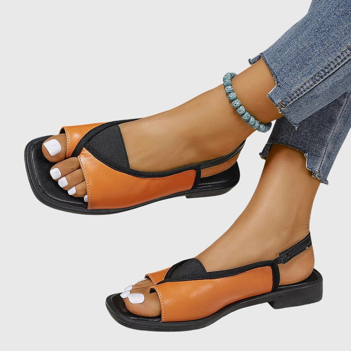 Close-up of square open toe and colorblock upper on women's flat slip-on sandals