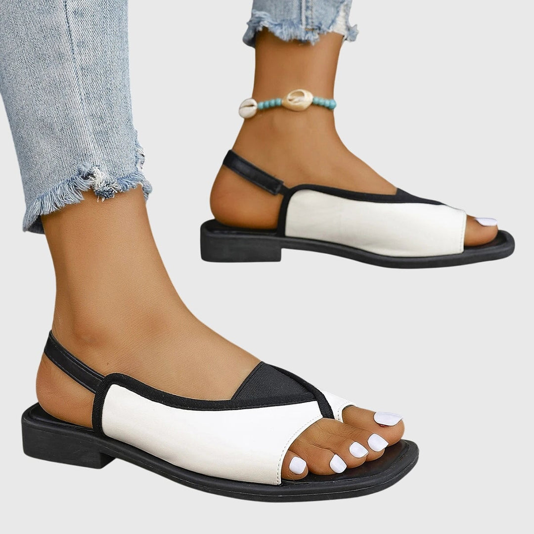 Women's colorblock flat sandals styled with a casual summer outfit, full look view