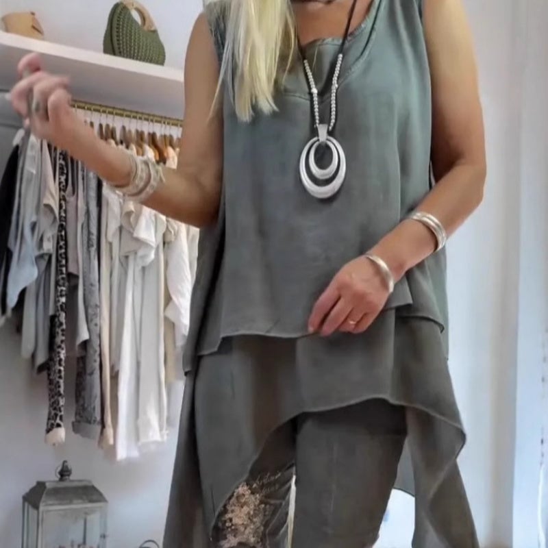 Lifestyle shot of the asymmetric sleeveless top and floral wide-leg pants set worn as a complete outfit