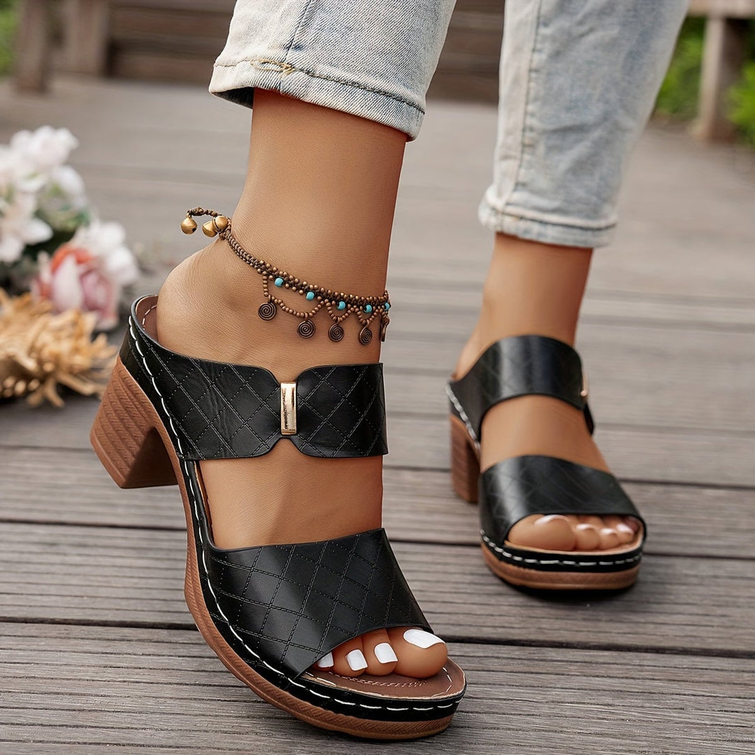 Zelda women's sandal in black, side view on neutral background