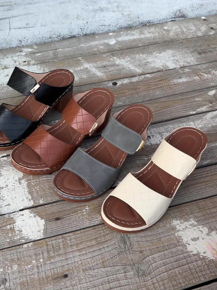 Close-up of model's feet in Zelda sandals in black, showing secure fit and elegant silhouette