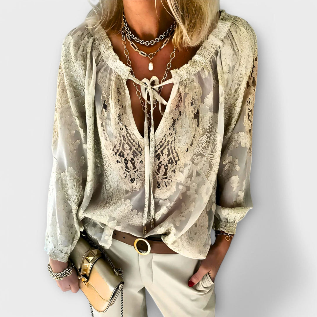 Zeleste lace blouse styled with high-waisted jeans showing deep V-neckline and romantic lace design