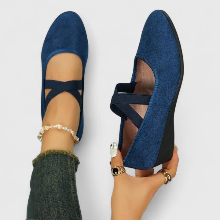 Zephyra Mary Jane flats shown from the side highlighting the flat sole and cross strap design