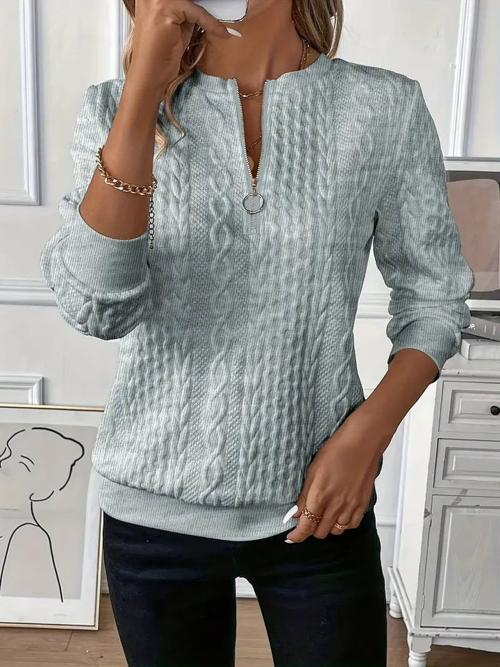 White cable knit zip-up sweater styled casually, full-length model shot