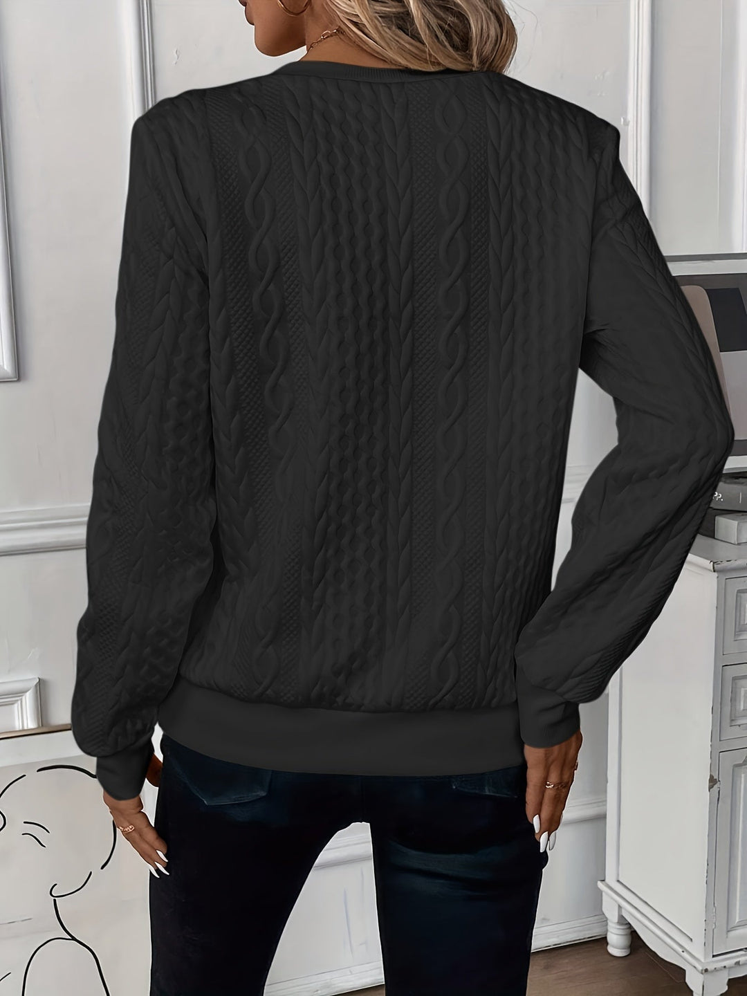 Detail shot of the front zipper closure on a cable knit sweater