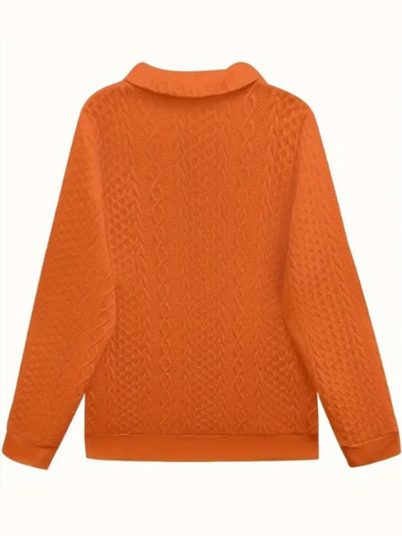 Flat lay of a cable knit zip-up sweater showing texture and knit pattern